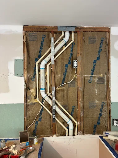 PVC drain and vent rough-in in wall framing